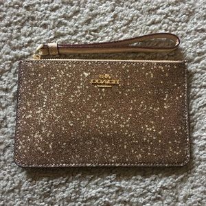 Gold glitter Coach wristlet with stars